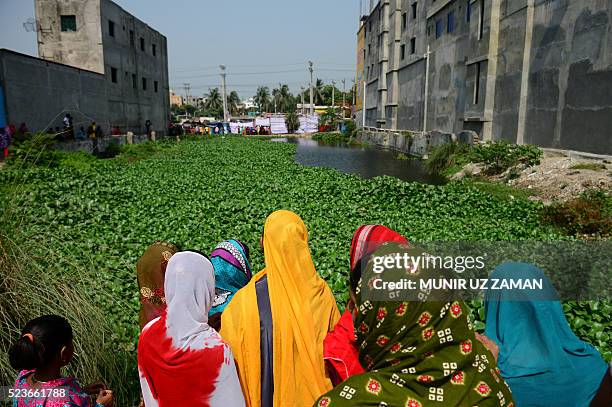 Bangladeshi onlookers gather at the site of the Rana Plaza building collapse on the third anniversary of the disaster in Savar, on the outskirts of...