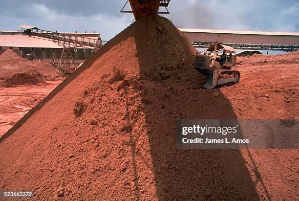 piles of bauxite at suralco refinery in moengo - suriname stockfoto's en -beelden