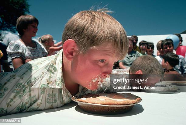 boys in a pie eating contest - eating competition stock pictures, royalty-free photos & images