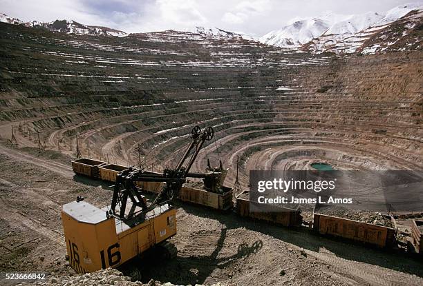 crane fills railroad cars at bingham canyon mine - bingham canyon mine stock pictures, royalty-free photos & images