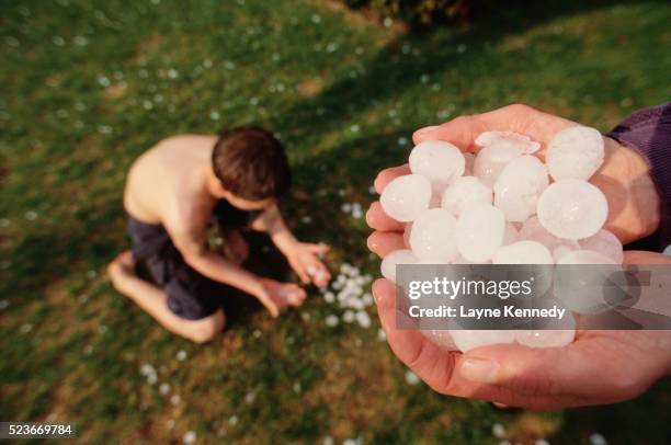 hands holding large hail balls - hail stock pictures, royalty-free photos & images