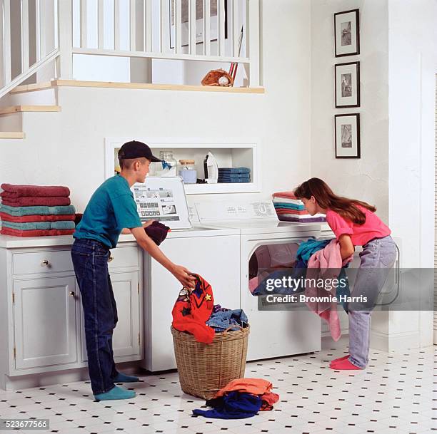 siblings doing laundry - chores stock pictures, royalty-free photos & images