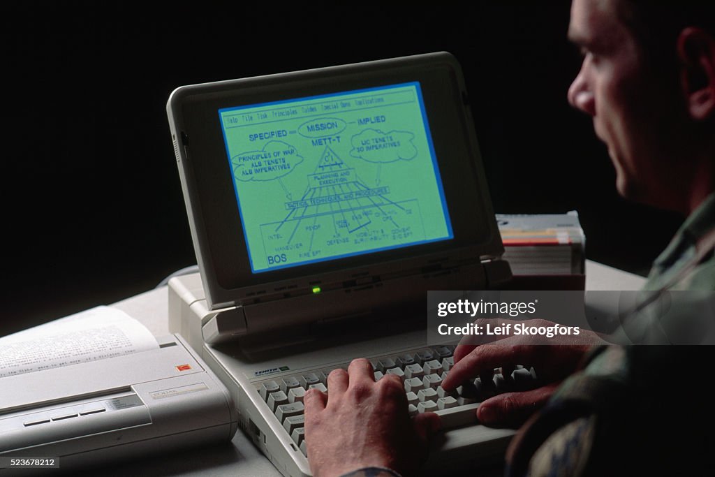 Militarty Rover Computer A United States Army Special Forces soldier studies lap top computing ...