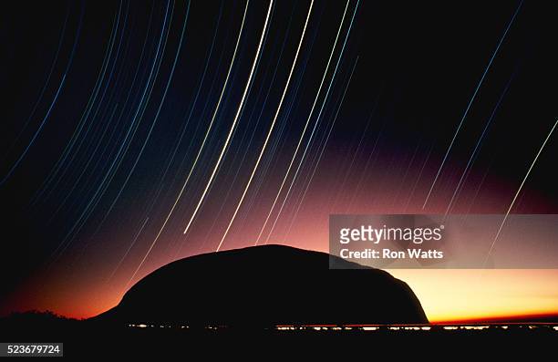 star trails over ayers rock - uluru stock pictures, royalty-free photos & images