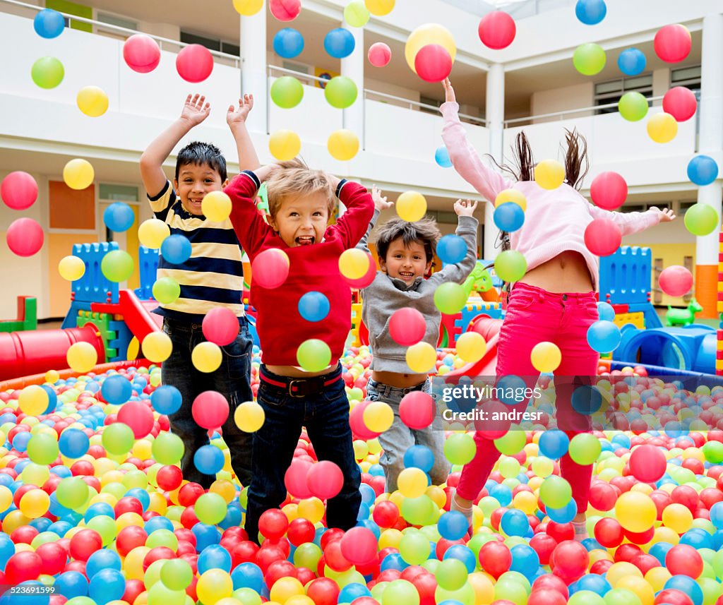 Kids playing at a ball pool