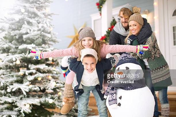 family playing outdoors. - father and mother with their daughter playing in the snow stock pictures, royalty-free photos & images