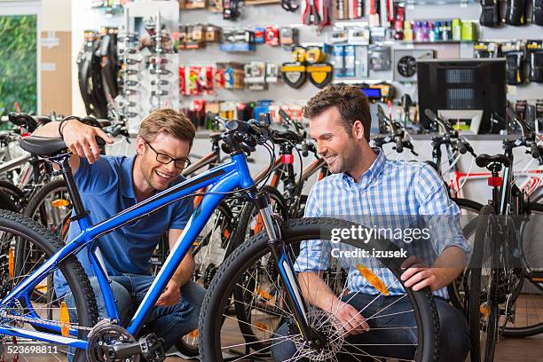 man buying bicycle in sport store - buying a bike bildbanksfoton och bilder