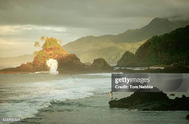 dark sky over jagged samoa coastline - samoa stock pictures, royalty-free photos & images