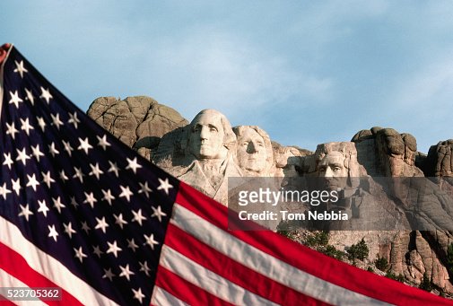 American Flag With Mount Rushmore Behind