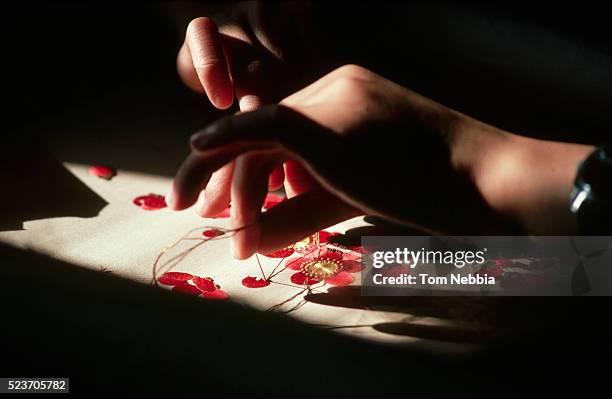 close-up of embroidering flowers on silk, china - embroidery stock pictures, royalty-free photos & images