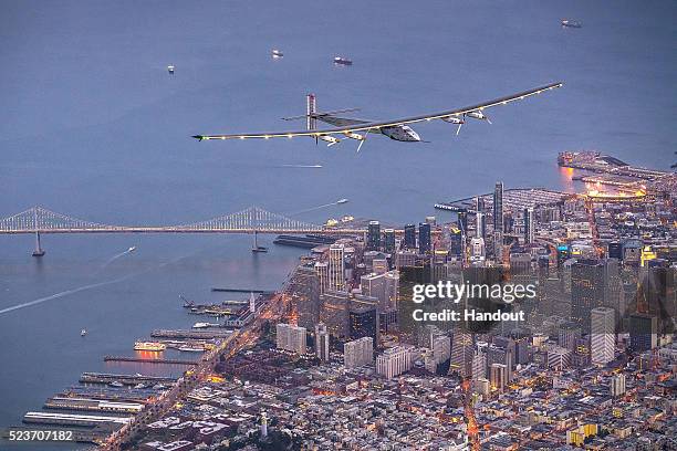 In this handout image supplied by Jean Revillard, Solar powered plane 'Solar Impulse 2', piloted by Swiss adventurer Bertrand Piccard, flys over the...