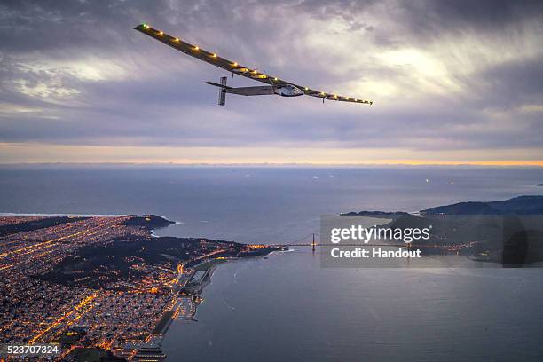 In this handout image supplied by Jean Revillard, Solar powered plane 'Solar Impulse 2', piloted by Swiss adventurer Bertrand Piccard, flys over the...