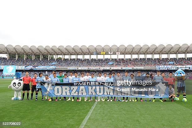 Players pose for photograph with a message for Kumamoto earthquake prior to the J.League match between Kawasaki Frontale and Urawa Red Diamonds at...
