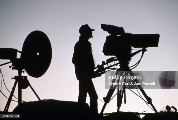 silhouetted cameraman - camera operator stock pictures, royalty-free photos & images