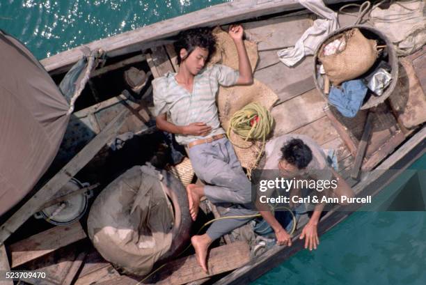 two refugees on ramshackle boat - vietnamese ethnicity stock pictures, royalty-free photos & images