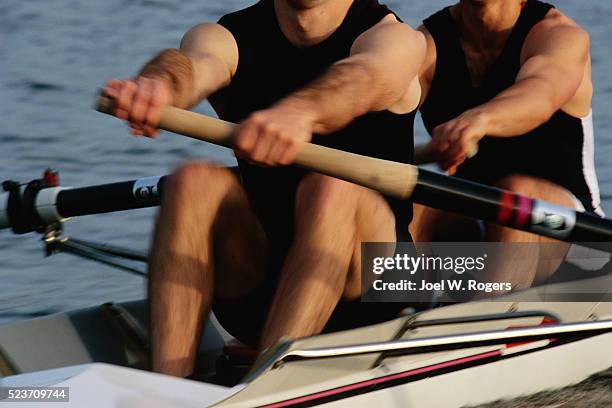 rowing team in a two man racing shell - rennrudern stock-fotos und bilder