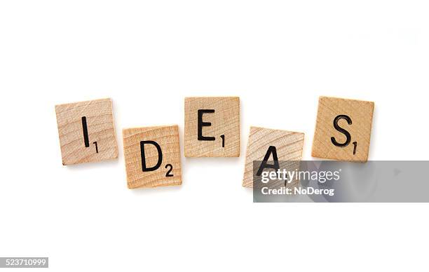 scrabble letter tiles spelling out ideas - scrabble stockfoto's en -beelden