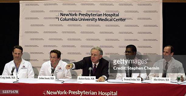 Flanked by members of the surgical team, New York Presbyterian Hospital President and CEO Dr. Herbert Pardes points to a reporter during a press...