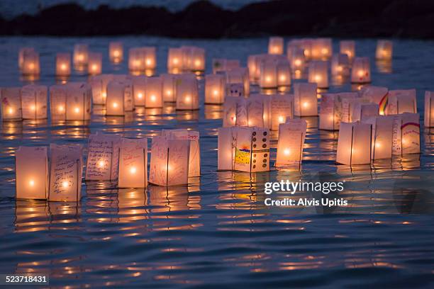 floating lantern ceremony to remember departed - floating lanterns stock pictures, royalty-free photos & images