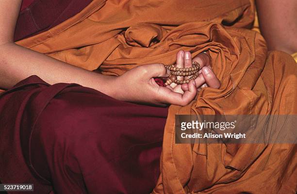 nun with prayer beads - buddist nun stock pictures, royalty-free photos & images