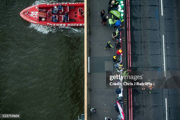 Visually impaired runner and his companion cross over Tower Bridge, as seen from the glass floor of Tower Bridge walkway, during the 36th London...