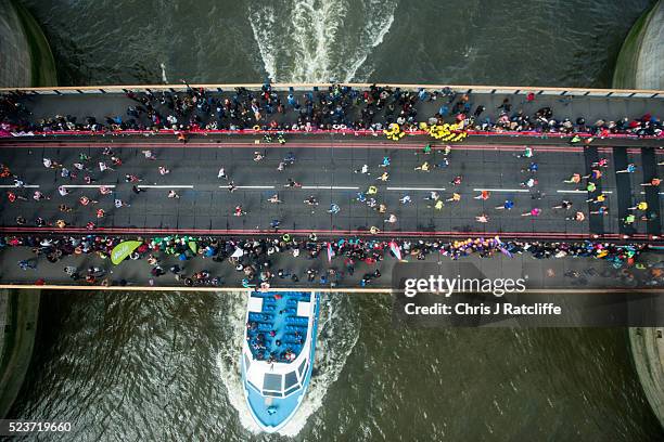 Runners cross the Rive Thames via Tower Bridge during the Virgin London Marathon 2016 on April 24, 2016 in London, England.