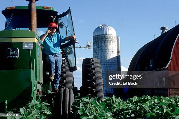 farmer using cellular telephone - archive farms stock-fotos und bilder