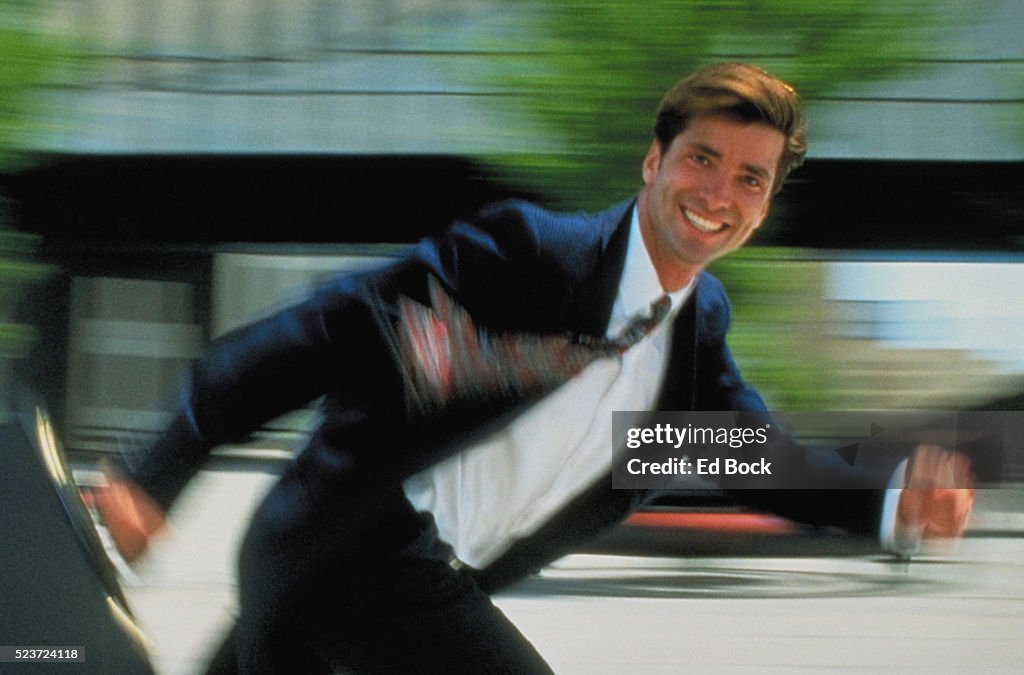 Cheerful Businessman with Briefcase Running