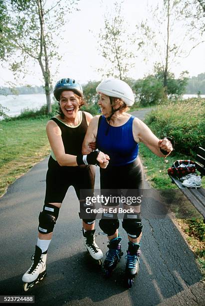 women inline skating - young at heart stock pictures, royalty-free photos & images