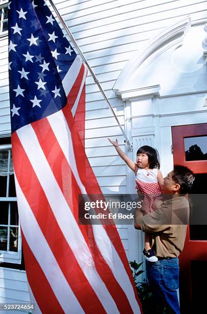 father and daughter looking at american flag - asian flags ストックフォトと画像