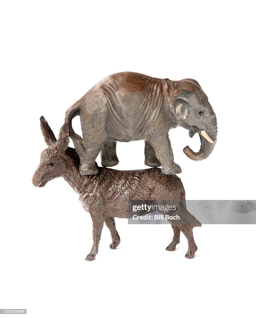 Republican elephant standing on democratic donkey