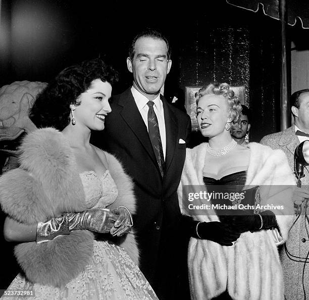 Actress Debra Paget poses with Fred MacMurray and wife June Haver as they attend the movie premiere of "Prince Valiant" at Romanoff's in Los...