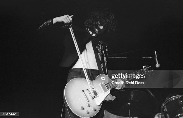 Guitarist Jimmy Page of Led Zeppelin, bows his instrument to novel effect, Cardiff, December 1972.