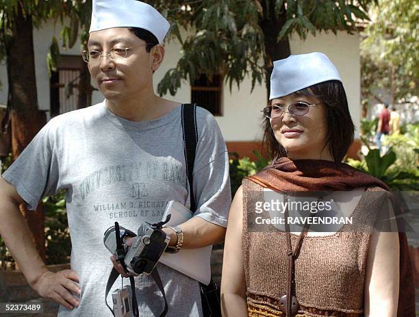 Chinese Professor Shang Quan-Yu and student Tanglu arrrive at Sabarmathi Asharmam in Ahmedabad in the western state of Gujarat, 11 March 2005, the...