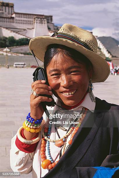 tibetan woman using a cellular telephone - tibetan ethnicity stock pictures, royalty-free photos & images