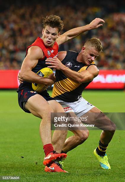 Jack Viney of the Demons is tackled by Brandon Ellis of the Tigers during the round five AFL match between the Melbourne Demons and the Richmond...