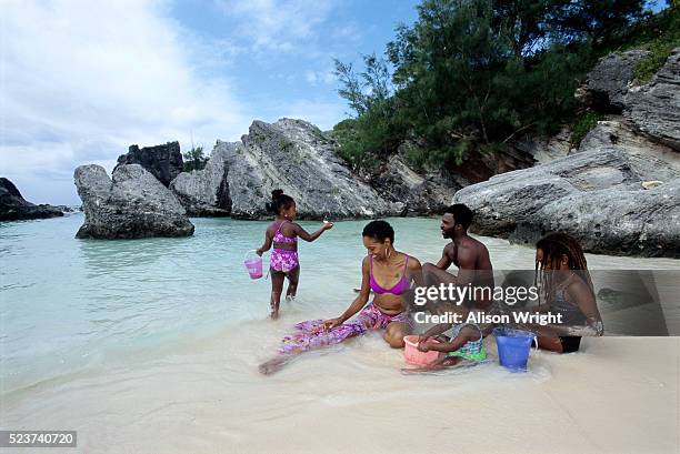 family playing at the beach - bermuda beach stock-fotos und bilder