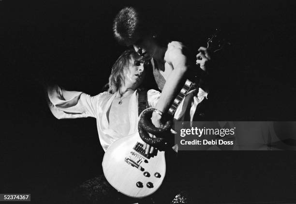 David Bowie and guitarist Mick Ronson play a guitar together during Bowie's last appearance as Ziggy Stardust, at the Hammersmith Odeon, London, 3rd...