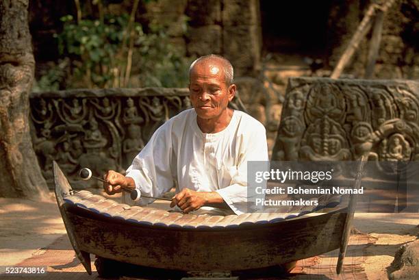 playing the xylophone in cambodia - cambodian xylophone stock pictures, royalty-free photos & images