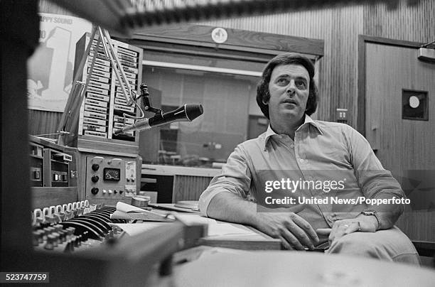 Irish radio and television broadcaster, Terry Wogan pictured sitting in a broadcasting studio at BBC Broadcasting House in London on 2nd October 1978.