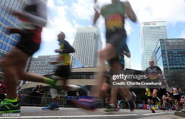 Participants run through Canary Wharf during the 2016 Virgin Money London Marathon on April 24, 2016 in London, England.