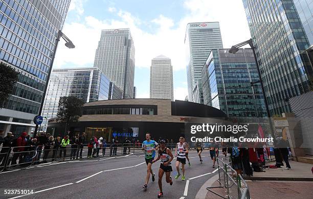 Participants run through Canary Wharf during the 2016 Virgin Money London Marathon on April 24, 2016 in London, England.