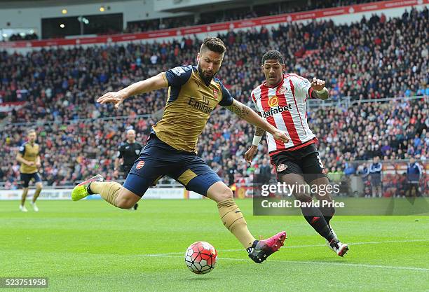 Olivier Giroud of Arsenal shoots under pressure from Patrick van Aanholt of Sunderland during the Barclays Premier League match between Sunderland...