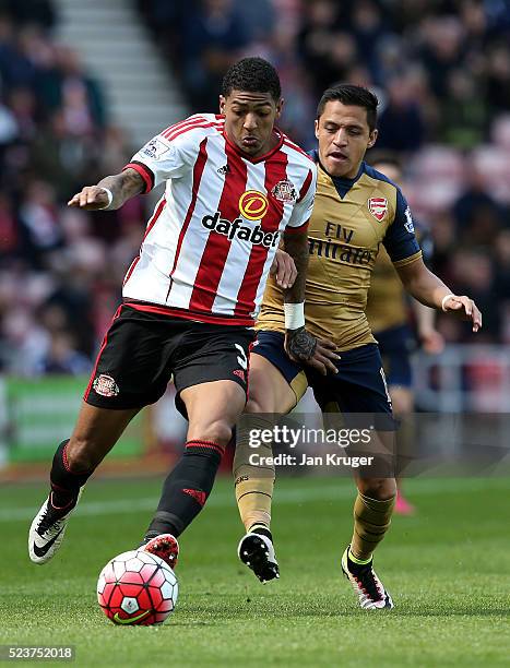 Patrick van Aanholt of Sunderland and Alexis Sanchez of Arsenal battle for the ball during the Barclays Premier League match between Sunderland and...