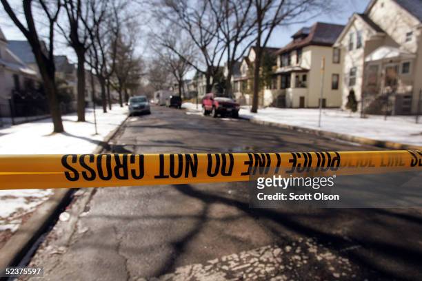 Crime-scene tape stops all but the residents at the end of the block where murder suspect Bart Ross lived on the city's northwest side March 11, 2005...