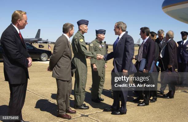 In this handout photo from the U.S. Air Force, U.S. President George W. Bush shakes hands with 8th Air Force commander Lt Gen Bruce Carlson while...