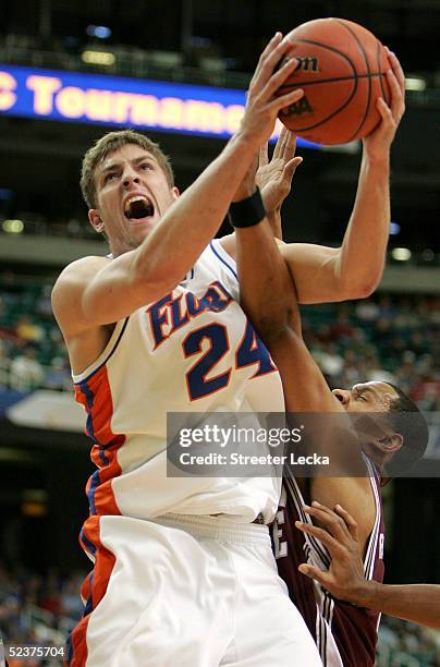 David Lee of the Florida Gators goes to the basket against Lawrence Roberts of the Mississippi State Bulldogs during the quarterfinals of the SEC...