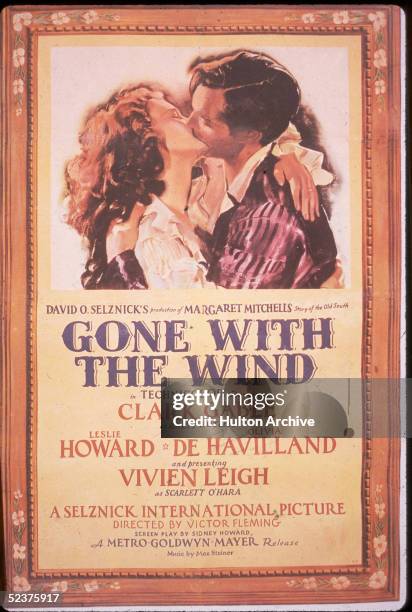 British actress Vivien Leigh as Scarlett O'Hara kisses American actor Clark Gable as Rhett Butler in this promotional poster for the movie 'Gone With...