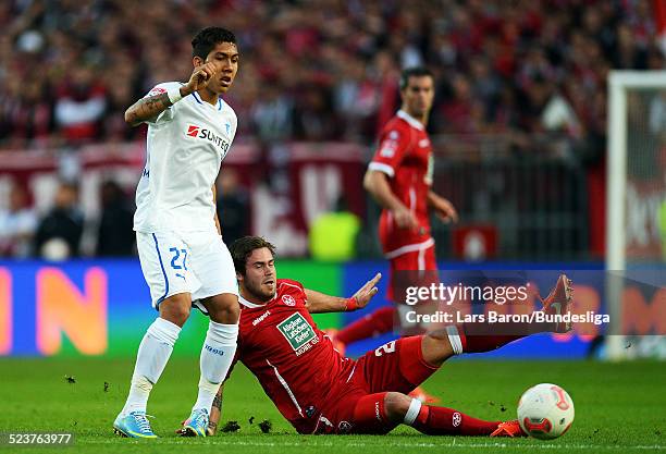 Roberto Firmino of Hoffenheim is challenged by Steven Zellner during the Bundesliga Playoff second leg match between 1. FC Kaiserslautern and 1899...