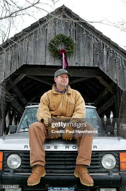 Ron Galotti sits on his Range Rover in front of a covered bridge on the property of a friend January 19, 2005 near North Pomfret, Vermont.